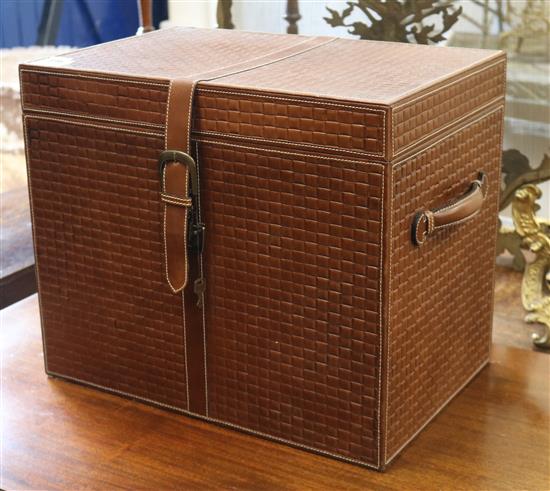 A brown leather chest with securing strap W.46cm